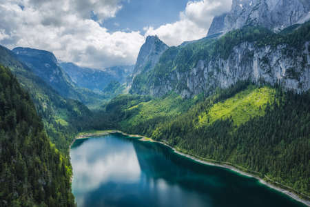 Aerial view of Gosau lake and Dachstein summit mountain range and visible glacier ice during summertime, Upper-Austria, Europeの写真素材