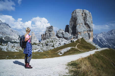 Hiker with backpack explore Cinque Torri mountains in Dolomites, Italyの写真素材