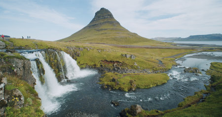 green mountain peak and kirkjufellsfoss fall is popular attractions at morning at Iceland, Summertime trip in iceland, shot slow motionの写真素材