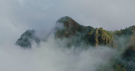 Epic morning fog in mountains and clouds at sunrise on Tenerife, Canary Islands. Teide National Park. Sunshine on peaks of rocks.の写真素材