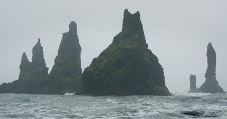 The cliffs and waves at the black sand beach, Reynisfjara in Vik, Icelandの写真素材