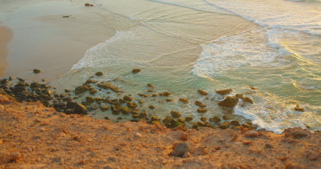 Sea and rocks on beautiful natural rocky beach at summer sunset. Waves crushing on wild paradise...
