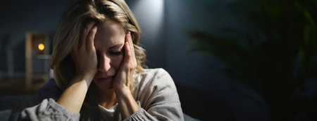 Stressed frustrated middle aged lady suffering from headache massaging temples, close up face. Tired sick mature old woman feeling unwell, touching head. Migraine pain, fatigue, stress concept. Panorama with copy space.の素材
