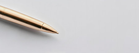 Gold ballpoint pen on a minimalistic white background, emphasizing simplicity and elegance, perfect for a business or professional context..の素材