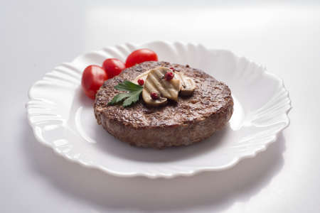 Burger, grilled mushrooms, tomatoesの写真素材