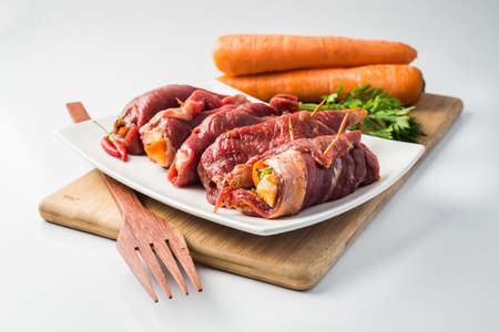 Steak a turtleneck, stuffed meat with vegetables, carrots and parsleyの写真素材