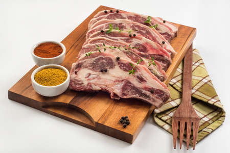 beef rib, spices, black pepper on wooden cutting boardの写真素材