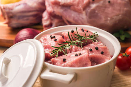 ham in the pot with black pepper and rosemaryの写真素材