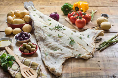 Codfish, Salted cod with potatoes, pepper, tomatoes, olives and oniosの写真素材