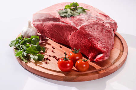 piece of meat on the wooden board