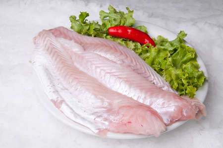 Codfish fillet with lettuce and pepper