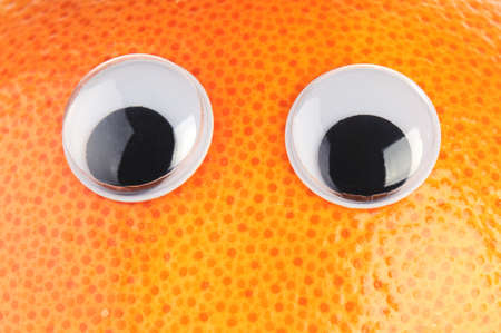 Orange grapefruit with eyes on a white backgroundの写真素材