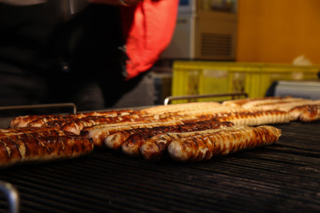 Grilled Sausages in the Grill are Being Prepared to be Served to Customersの写真素材