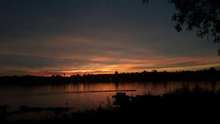 orange sunset over the barito river kahayan mahakamの写真素材