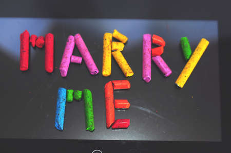 Marry me writing from colorful crayon piecesの写真素材