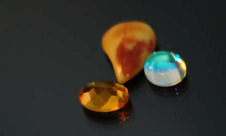 various agate on black glass mirror