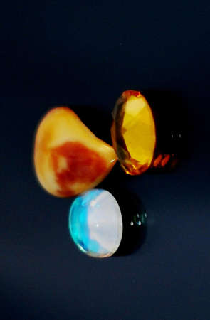 various agate on black glass mirror