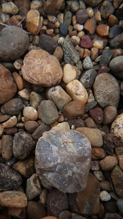 abstract Textured background with round pebble stones. Vacation holiday recreation on beach concept....