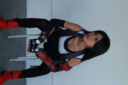 Portrait of a beautiful girl with black hair and red boxing gloves