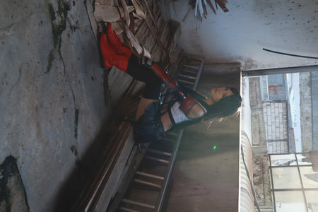 Young man climbing on a wall in an abandoned building, extreme sport