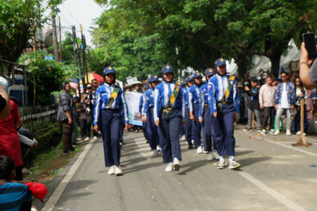 Unidentified Thai students are participating in a religious ceremony in front of the school.