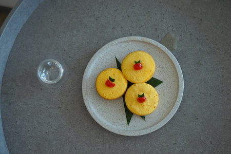 Cupcakes decorated with red pepper and green leaves on a plate