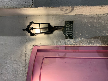 Old street lamp on the wall of a building in Paris, France