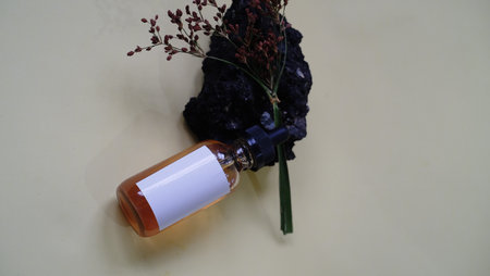 Bouquet of dried flowers and a bottle of perfume on a white background