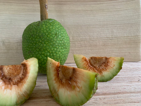 Pomelo fruit on the wooden table, green fruit with slice