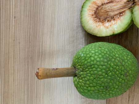 Green jackfruit on wooden table background with copy space for text.