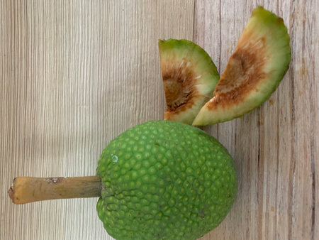 Green fruit on a wooden table. Top view. Healthy food concept.