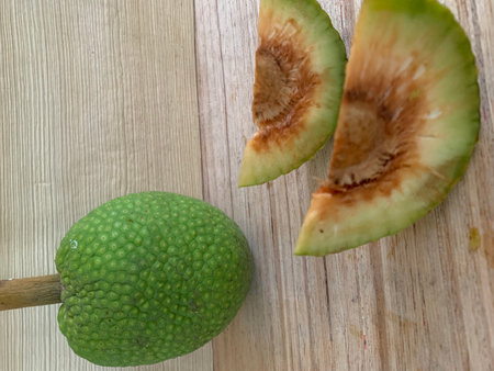 Sliced fruit on a wooden table, top view.