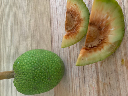 Slices of green fruit on a wooden table
