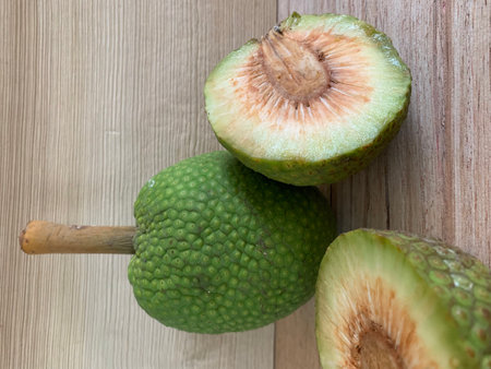 Close up of green jackfruit on a wooden table, stock photo