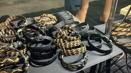 Black and gold belts for sale in a flea market.