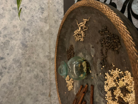 Spices and a glass jar on a wooden trayの写真素材