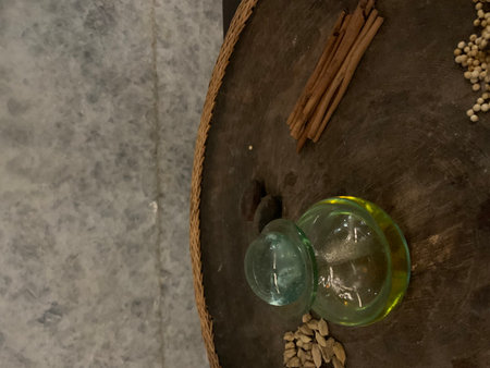 Cinnamon sticks and a bottle of olive oil on a dark background
