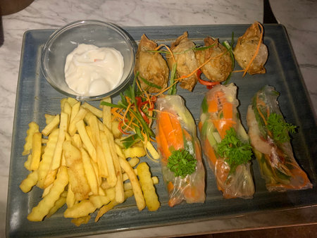 Fried spring rolls with vegetables and mayonnaise on a plate