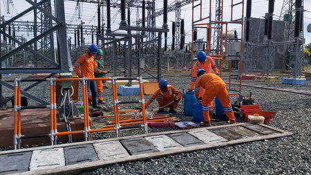 Workers are working on the construction of a high-voltage substation.
