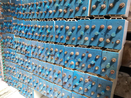 Close up of a row of blue electrical boxes in a factory.