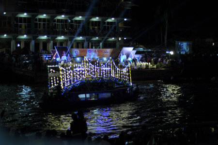 Tourist boats on the Chao Phraya River at night.