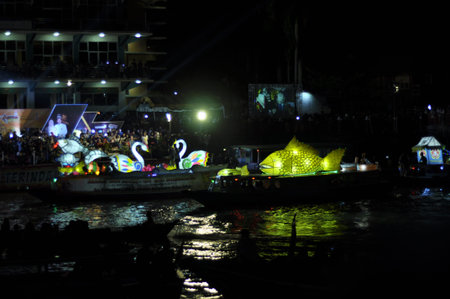 Tourists and Thai people enjoy floating on the Chao Phraya River at night.