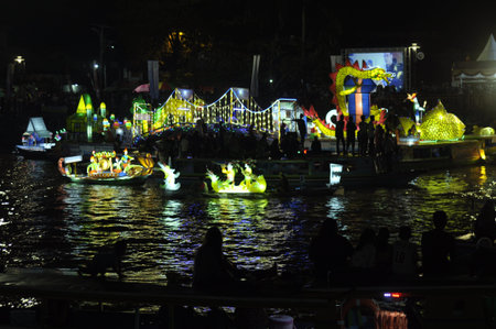 Unidentified people on the floating market of Bangkok at night.