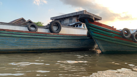 Fishing boats on the shore of the Mekong River in Vietnamの写真素材
