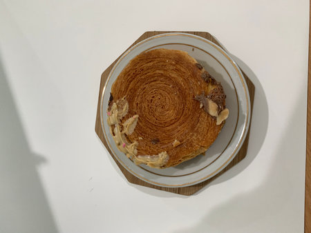 Coffee cake with almond on a white background, top view