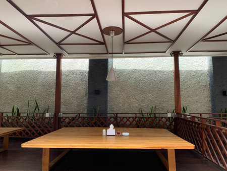 Interior of a restaurant with a wooden terrace. Nobody inside