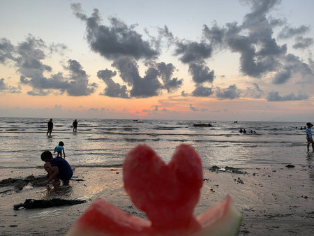 Watermelon on the beach at sunset in Bali, Indonesia.