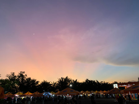 Silhouette of people at sunset in the park, Thailand.の写真素材