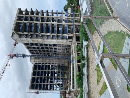 High rise building under construction with blue sky background, Bangkok, Thailand