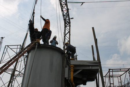Workers are working on the construction of high-voltage substation.